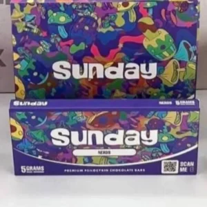 Unwrapped Sunday Nerds Mushroom Chocolate Bar showcasing a creamy chocolate base adorned with colorful Nerds candy pieces